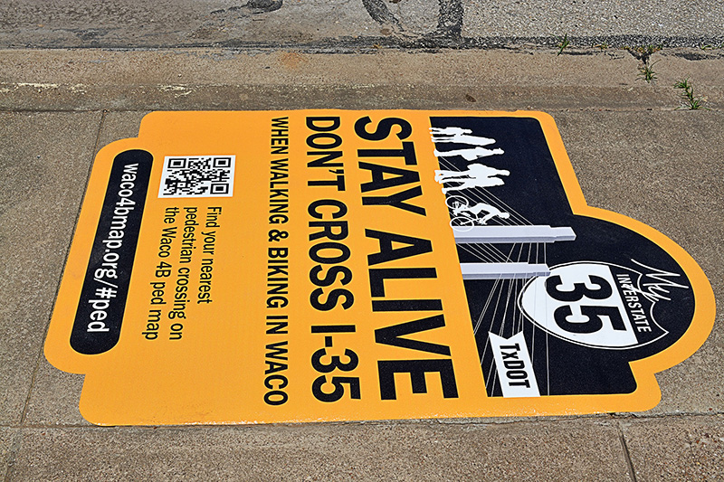 Stay Alive. Don't cross I-35 sign.