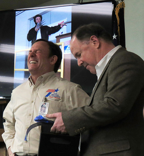 Waco City Manager Dale Fisseler presents Littlefield with a gift